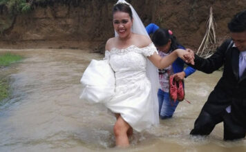 Philippines couple walking through a flooded river